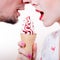 closeup on happy couple eating one icecream cone isolated on white copy space background