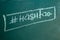 Closeup on hashtag symbol white chalk on a blackboard copy space background