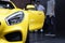 Closeup headlight of sport yellow car and opening door background