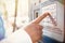 Closeup headshot of young African man trying to check balance on his credit card using automatic teller machine. Blurred