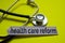 Closeup health care reform with stethoscope concept inspiration on yellow background