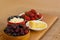 Closeup of healthy breakfast: cottage cheese, strawberries, cherry and sliced cheese on wooden board. Retro styled photo.