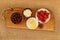 Closeup of healthy breakfast: cottage cheese, strawberries, cherry and sliced cheese on wooden board. Retro styled photo.