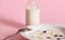 Closeup of healthy delicious breakfast from fresh milk and a plate of muesli with berries, isolated on pink background