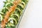 Closeup of healthy salmon salad with avocado and organic vegetables with mustard sauce, selective focus