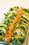 Closeup of healthy salmon salad with avocado and organic vegetables with mustard sauce, selective focus