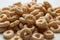 Closeup of a heap of rings breakfast cereal on white background