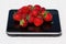 Closeup of a heap of strawberries on the electronic scales