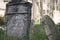 Closeup of Hebrew engravings on old stones in a graveyard under the sunlight