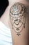Closeup henna tattoo on woman`s shoulder