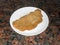 Closeup high angle of a classic fried veal cutlet Milanese on a white plate with a dark