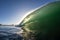 Closeup of a high clean  wave on the sea with sunshine behind