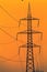 Closeup high voltage poles sunset