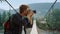 Closeup hipster photographing mountains landscape. Hiker take camera photo.