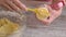 Closeup of a home baker putting dough into cookie press.