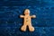 Closeup homemade Christmas cookies in form of gingerbread man on navy table