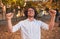 Closeup horizontal portrait of happy winner male student or businessman with curly hair smiling with winning expression, fists