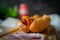 Closeup of a hot dog with pure beef sausage with onions on a wooden board.