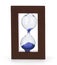 Closeup hourglass clock on light blue background