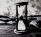 Closeup.hourglass with white sand on a wooden table