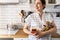 Closeup housewife posing with marking sticker names titles of bulk products on plastic case box