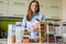 Closeup housewife posing with marking sticker names titles of bulk products on plastic case box