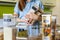 Closeup housewife posing with marking sticker names titles of bulk products on plastic case box