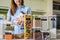 Closeup housewife posing with marking sticker names titles of bulk products on plastic case box