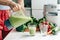 .Closeup housewife pours ready green smoothie