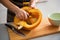 Closeup on housewife removing filling from pumpkin