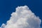 Closeup huge cumulus cloud on a blue sky