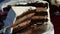 Closeup human hand make thin slice of big chocolate cake