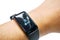 Closeup human`s hand wear black healthy smart band with numbers and icon of calories burned display on screen