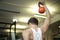 Closeup of a human training his muscles with a red dumbbell against a blurry background
