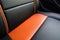 A closeup of a hybrid race cars interior featuring sleek leather and carbon fiber detailing and a vibrant orange Speed