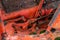 Closeup of hydraulic mechanism spring and wiring on old rusty russian tractor with grease oil autumn harvest machinery