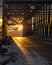 closeup of icy or snow covered road in Alaska under iron bridge and sunrise in background