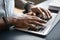 Closeup image african male hands typing on laptop keyboard