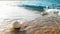 Closeup image of calm sea waves rolling and braking on the floating buoys on the sandy sea shore