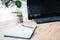 closeup image of empty textbook, pen, potted plant, computer and computer keyboard