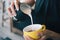 Closeup image of female hands pouring milk and preparing fresh latte, coffee artist and preparation concept, morning coffee