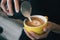 Closeup image of female hands pouring milk and preparing fresh latte, coffee artist and preparation concept, morning coffee