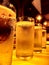 Closeup image of four transparent crystal clear water glasses filled with chilled water arranged in a row