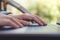 Closeup image of hands working , touching and typing on laptop keyboard with blur nature