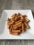 Closeup image of leftover tortiglioni pasta fried with an egg