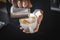 Closeup image of male hands pouring milk and preparing fresh cappuccino, coffee artist and preparation concept,