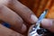 Closeup image of manicuring nails and smoothing edges with stainless steel file