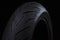 Closeup Image Of New Racing Road Motorcycle Tyre Against Black Background