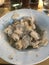 Closeup image of a plate of gnocchi topped with fresh truffle shavings