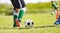 Closeup Image of soccer player legs and soccer ball on the field